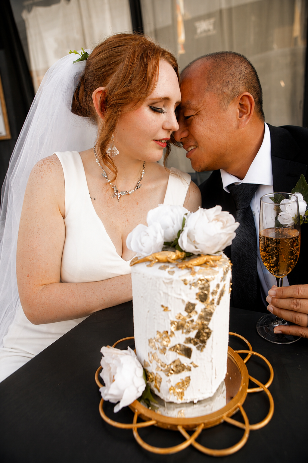 Rana and Nick during their intimate elopement in Mesa, Arizona, photographed by TallulahMade Photography. This romantic wedding portrait captures the couple celebrating their marriage against the warm desert architecture of Mesa, blending candid conn