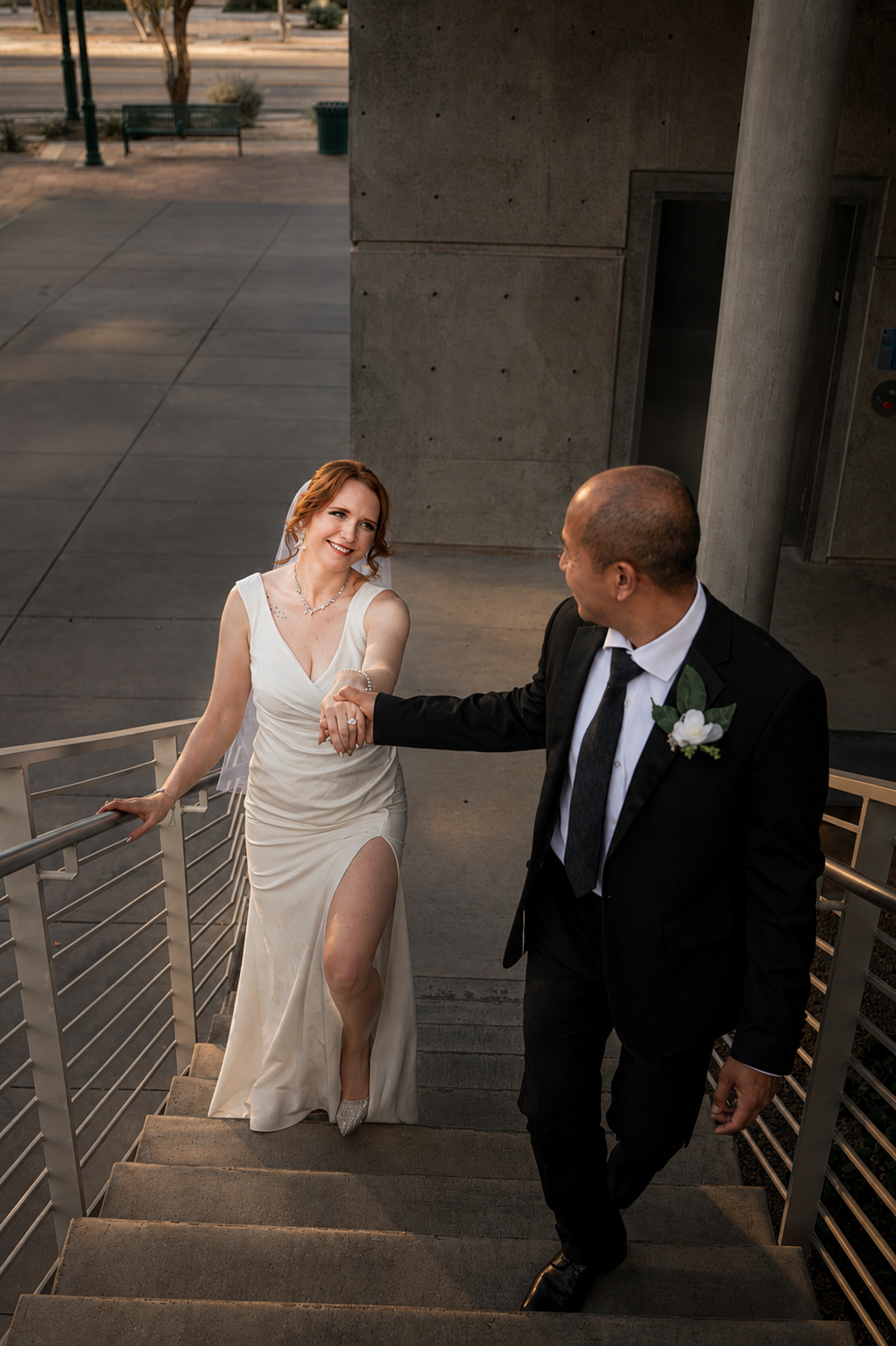 Rana and Nick during their intimate elopement in Mesa, Arizona, photographed by TallulahMade Photography. This romantic wedding portrait captures the couple celebrating their marriage against the warm desert architecture of Mesa, blending candid conn