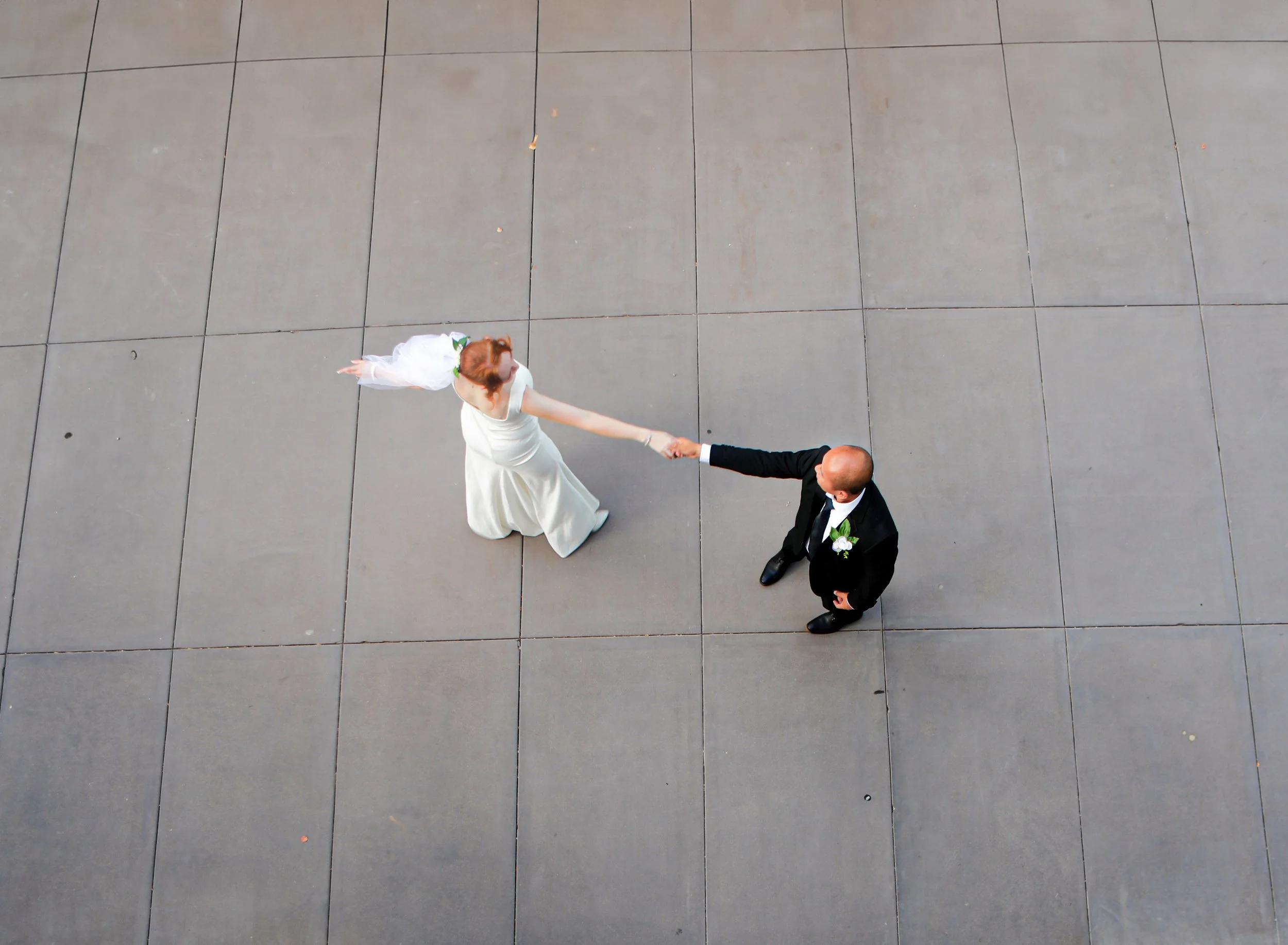 Rana and Nick during their intimate elopement in Mesa, Arizona, photographed by TallulahMade Photography. This romantic wedding portrait captures the couple celebrating their marriage against the warm desert architecture of Mesa, blending candid conn
