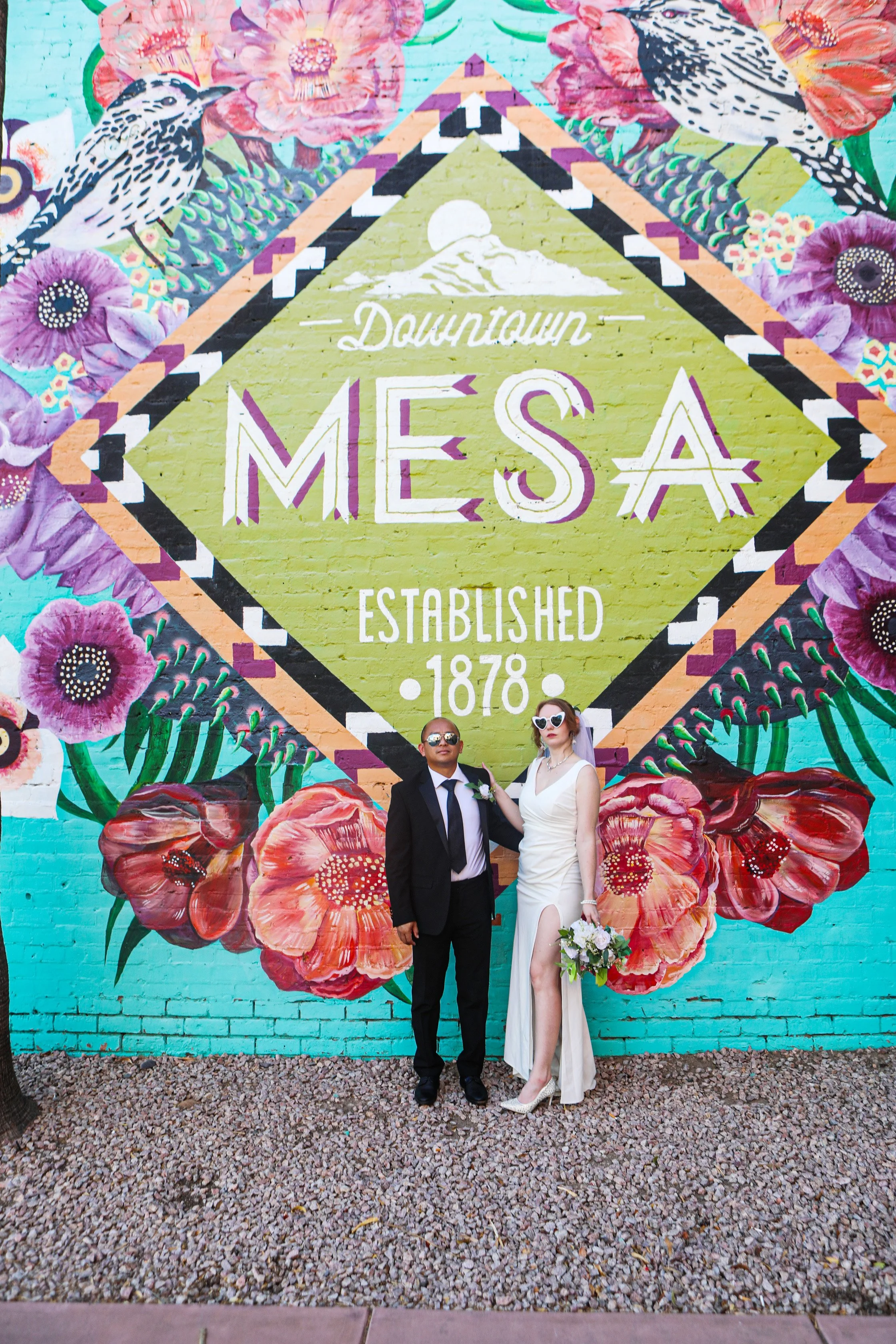 Rana and Nick during their intimate elopement in Mesa, Arizona, photographed by TallulahMade Photography. This romantic wedding portrait captures the couple celebrating their marriage against the warm desert architecture of Mesa, blending candid conn