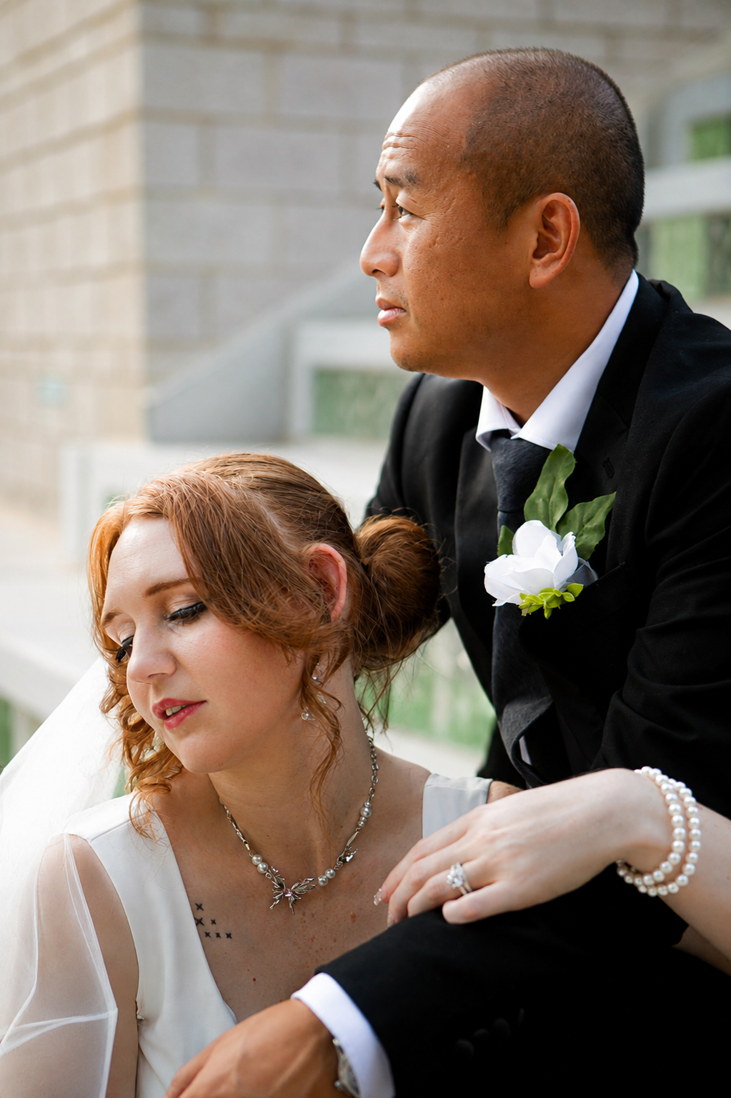 Rana and Nick during their intimate elopement in Mesa, Arizona, photographed by TallulahMade Photography. This romantic wedding portrait captures the couple celebrating their marriage against the warm desert architecture of Mesa, blending candid conn