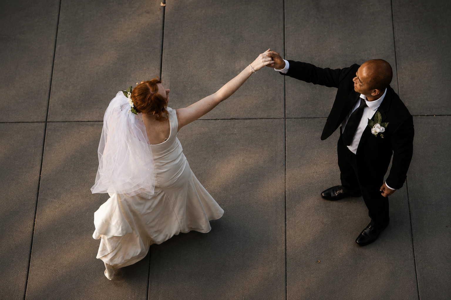 Rana and Nick during their intimate elopement in Mesa, Arizona, photographed by TallulahMade Photography. This romantic wedding portrait captures the couple celebrating their marriage against the warm desert architecture of Mesa, blending candid conn