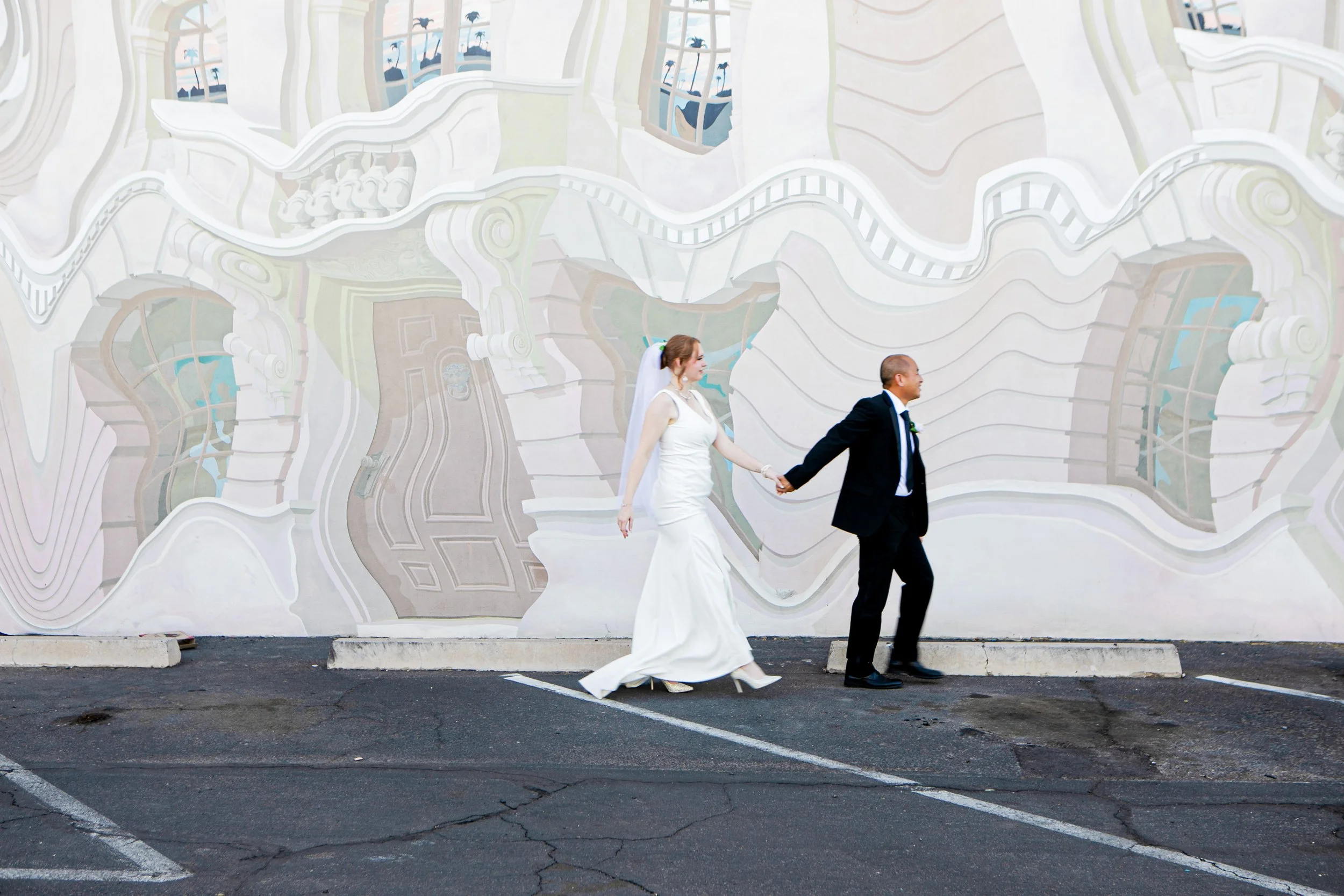 Rana and Nick during their intimate elopement in Mesa, Arizona, photographed by TallulahMade Photography. This romantic wedding portrait captures the couple celebrating their marriage against the warm desert architecture of Mesa, blending candid conn