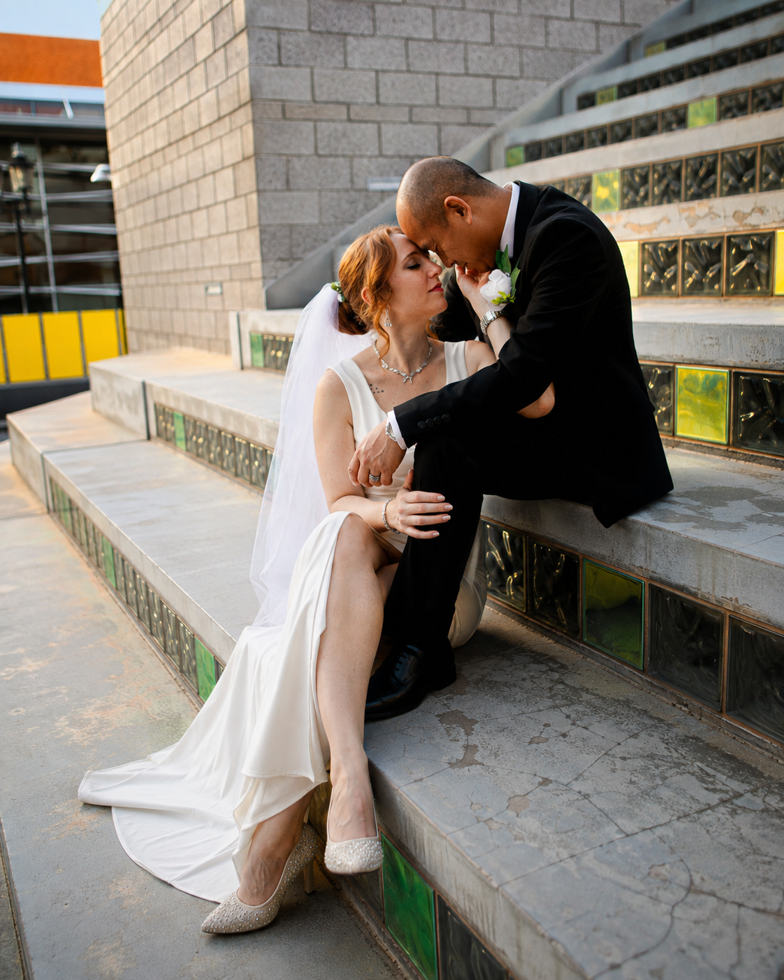 Rana and Nick during their intimate elopement in Mesa, Arizona, photographed by TallulahMade Photography. This romantic wedding portrait captures the couple celebrating their marriage against the warm desert architecture of Mesa, blending candid conn