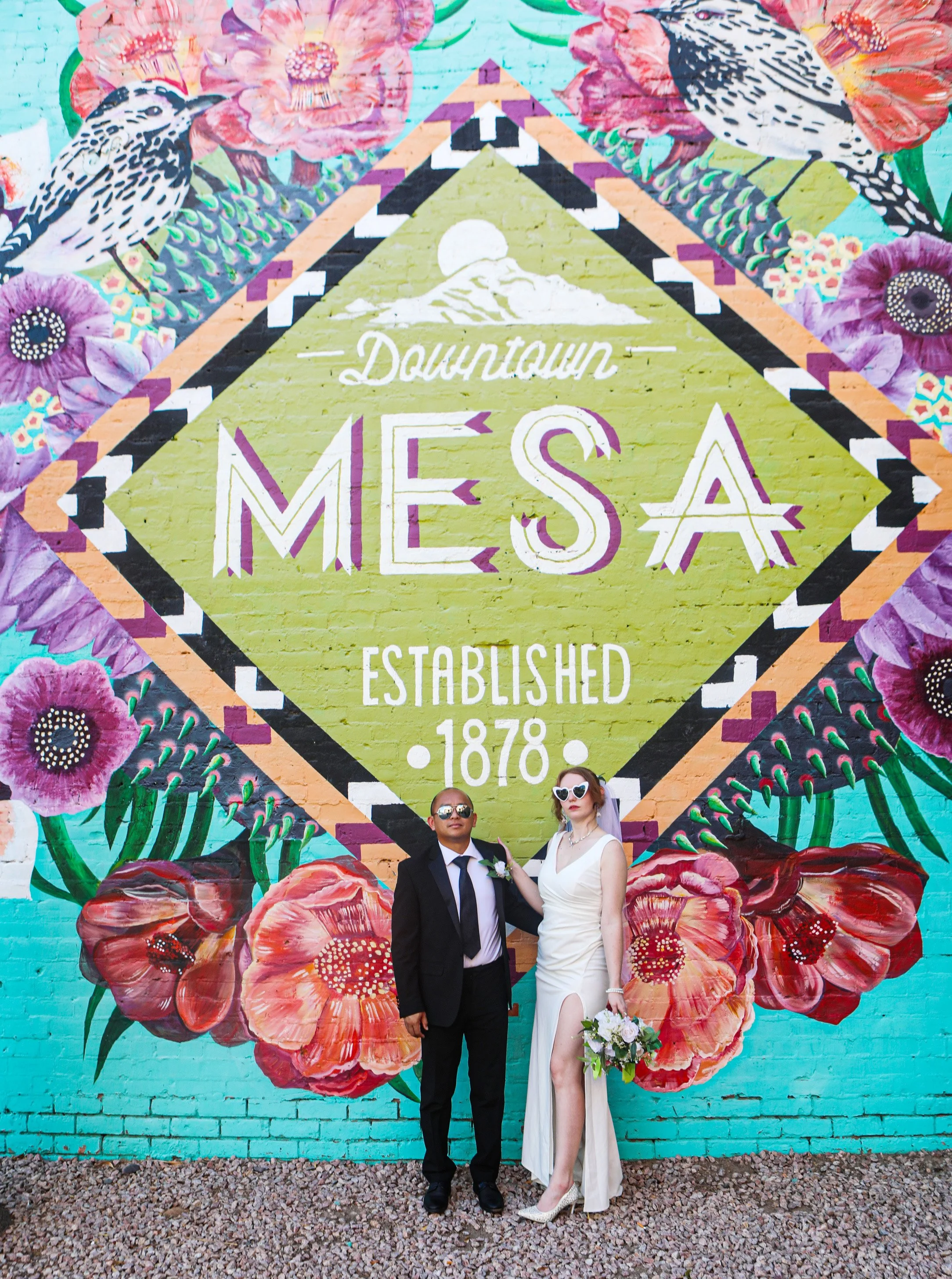 Rana and Nick during their intimate elopement in Mesa, Arizona, photographed by TallulahMade Photography. This romantic wedding portrait captures the couple celebrating their marriage against the warm desert architecture of Mesa, blending candid conn