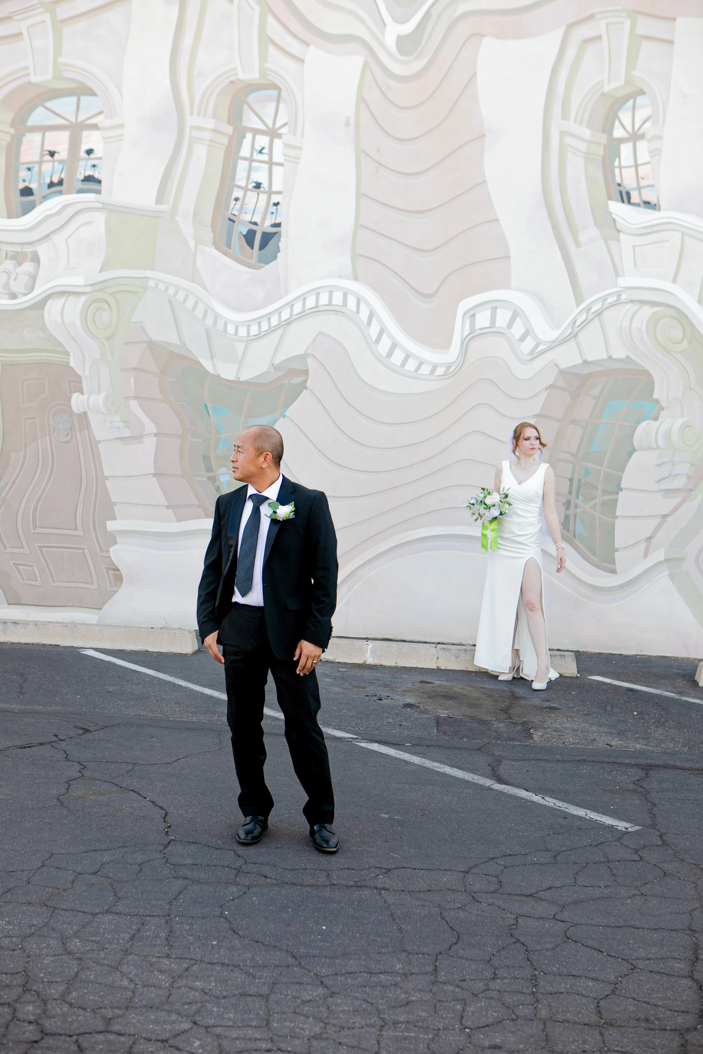 Rana and Nick during their intimate elopement in Mesa, Arizona, photographed by TallulahMade Photography. This romantic wedding portrait captures the couple celebrating their marriage against the warm desert architecture of Mesa, blending candid conn