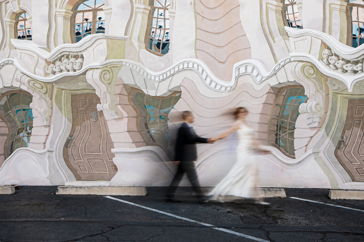 Rana and Nick during their intimate elopement in Mesa, Arizona, photographed by TallulahMade Photography. This romantic wedding portrait captures the couple celebrating their marriage against the warm desert architecture of Mesa, blending candid conn