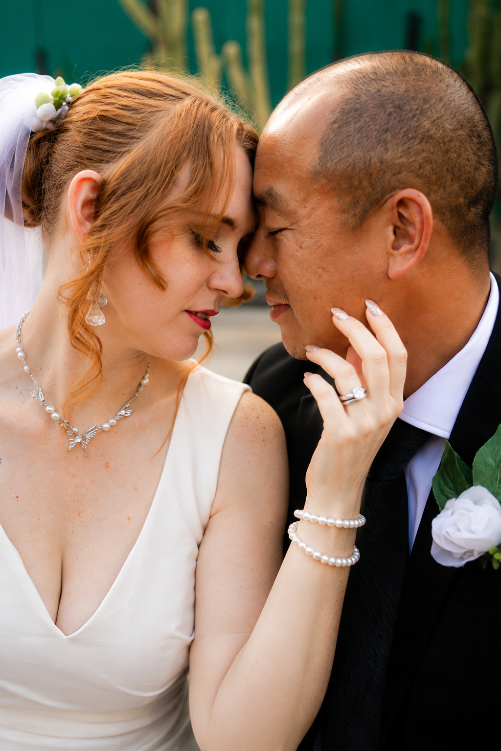 Rana and Nick during their intimate elopement in Mesa, Arizona, photographed by TallulahMade Photography. This romantic wedding portrait captures the couple celebrating their marriage against the warm desert architecture of Mesa, blending candid conn