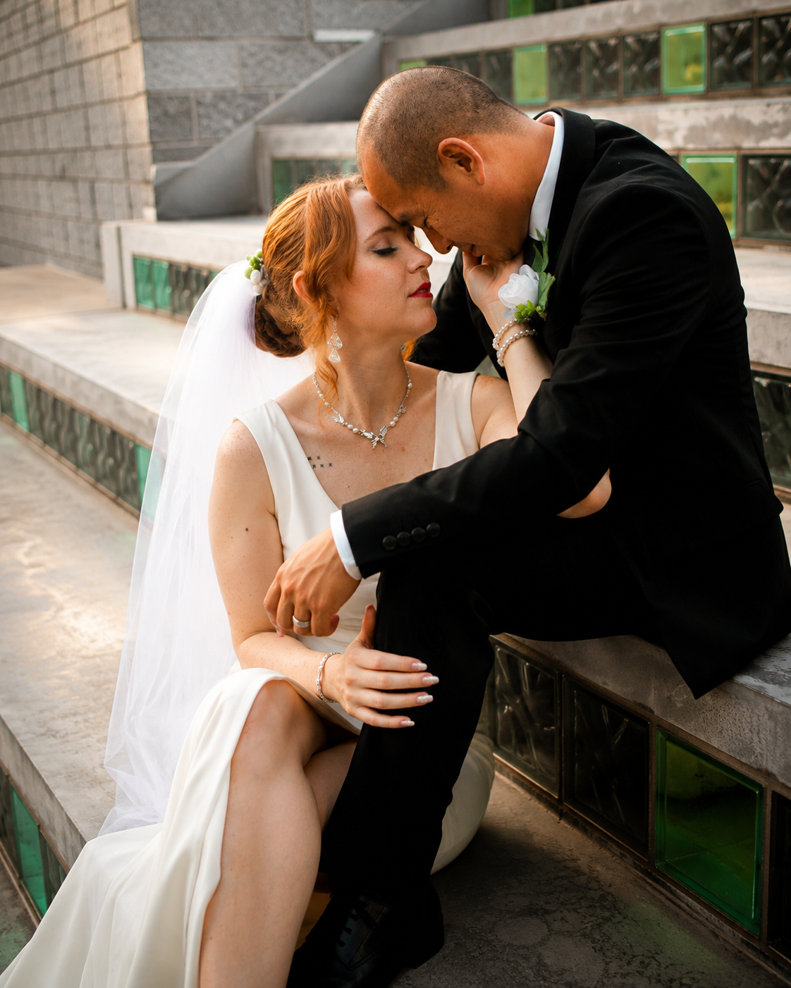 Rana and Nick during their intimate elopement in Mesa, Arizona, photographed by TallulahMade Photography. This romantic wedding portrait captures the couple celebrating their marriage against the warm desert architecture of Mesa, blending candid conn