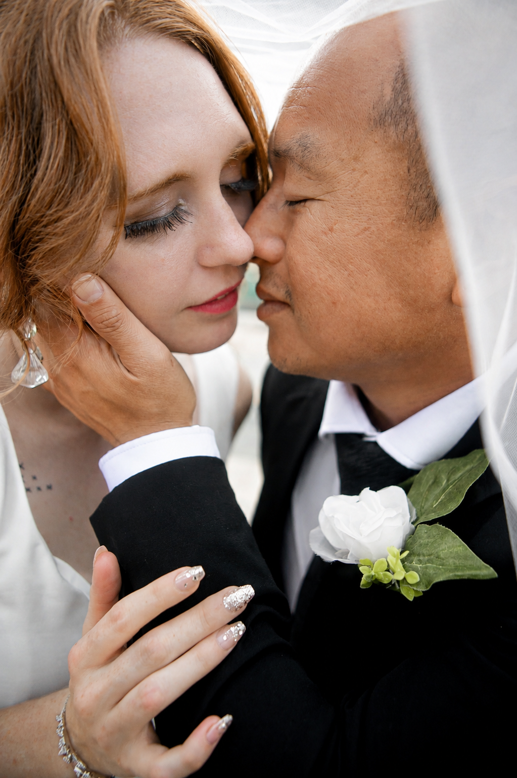 Rana and Nick during their intimate elopement in Mesa, Arizona, photographed by TallulahMade Photography. This romantic wedding portrait captures the couple celebrating their marriage against the warm desert architecture of Mesa, blending candid conn