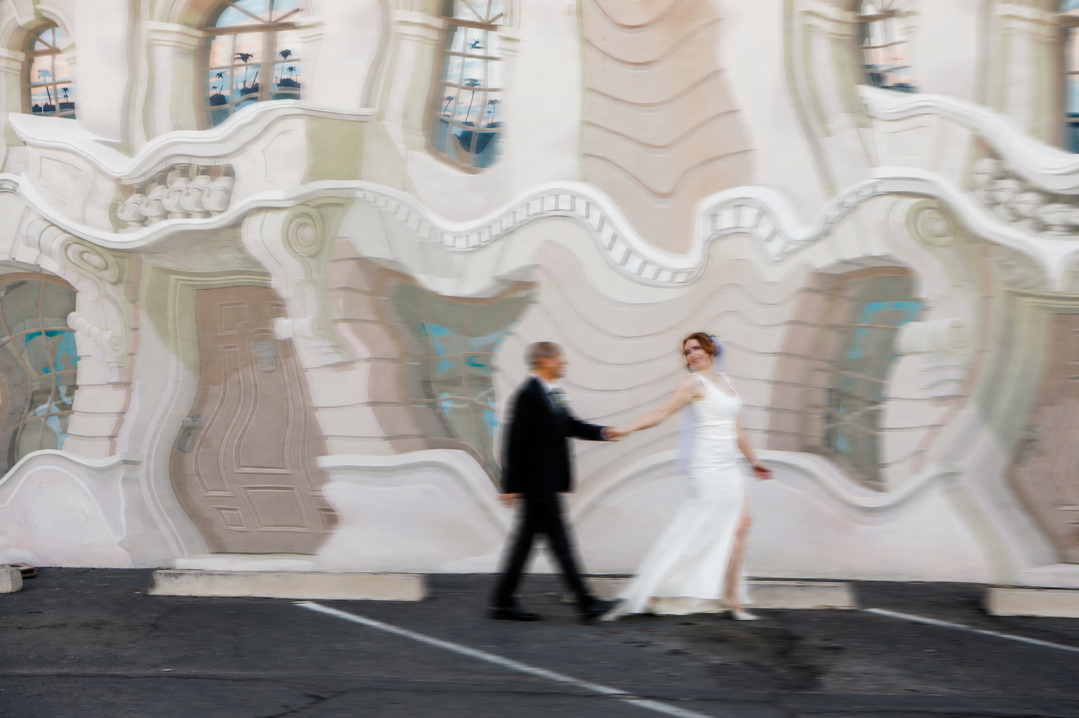 Rana and Nick during their intimate elopement in Mesa, Arizona, photographed by TallulahMade Photography. This romantic wedding portrait captures the couple celebrating their marriage against the warm desert architecture of Mesa, blending candid conn