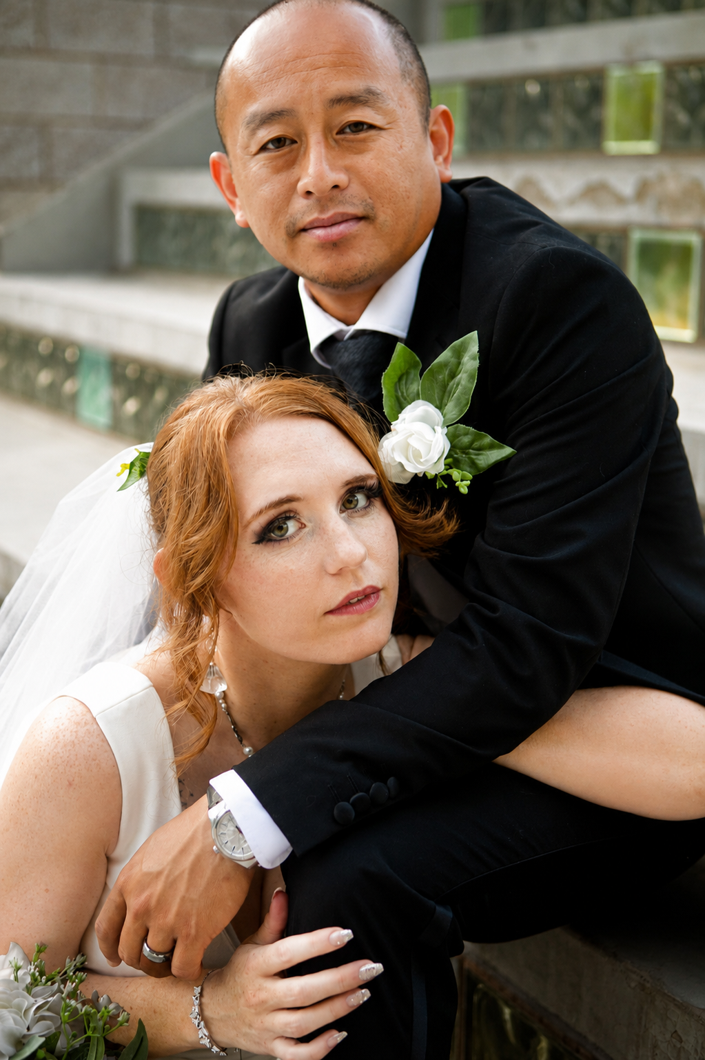 Rana and Nick during their intimate elopement in Mesa, Arizona, photographed by TallulahMade Photography. This romantic wedding portrait captures the couple celebrating their marriage against the warm desert architecture of Mesa, blending candid conn
