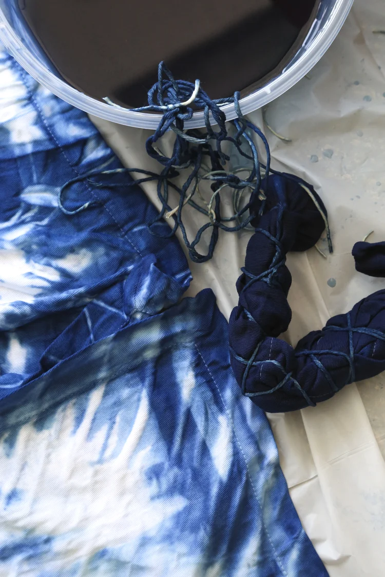 Susan Shepardson - Recently I learned about shibori - a Japanese dying technique that dates back to the 8th century. The main dye used in shibori is indigo which happens to be my favorite color so naturally I wanted to try it. I gathered all of the necessary materials and asked my friend Michelle to join me. We had so much fun creating napkins, tea towels and tank tops. The process is real open ended and produces unexpected and beautiful patterns. It's fun and easy to do; now my head is swimming with shibori ideas.