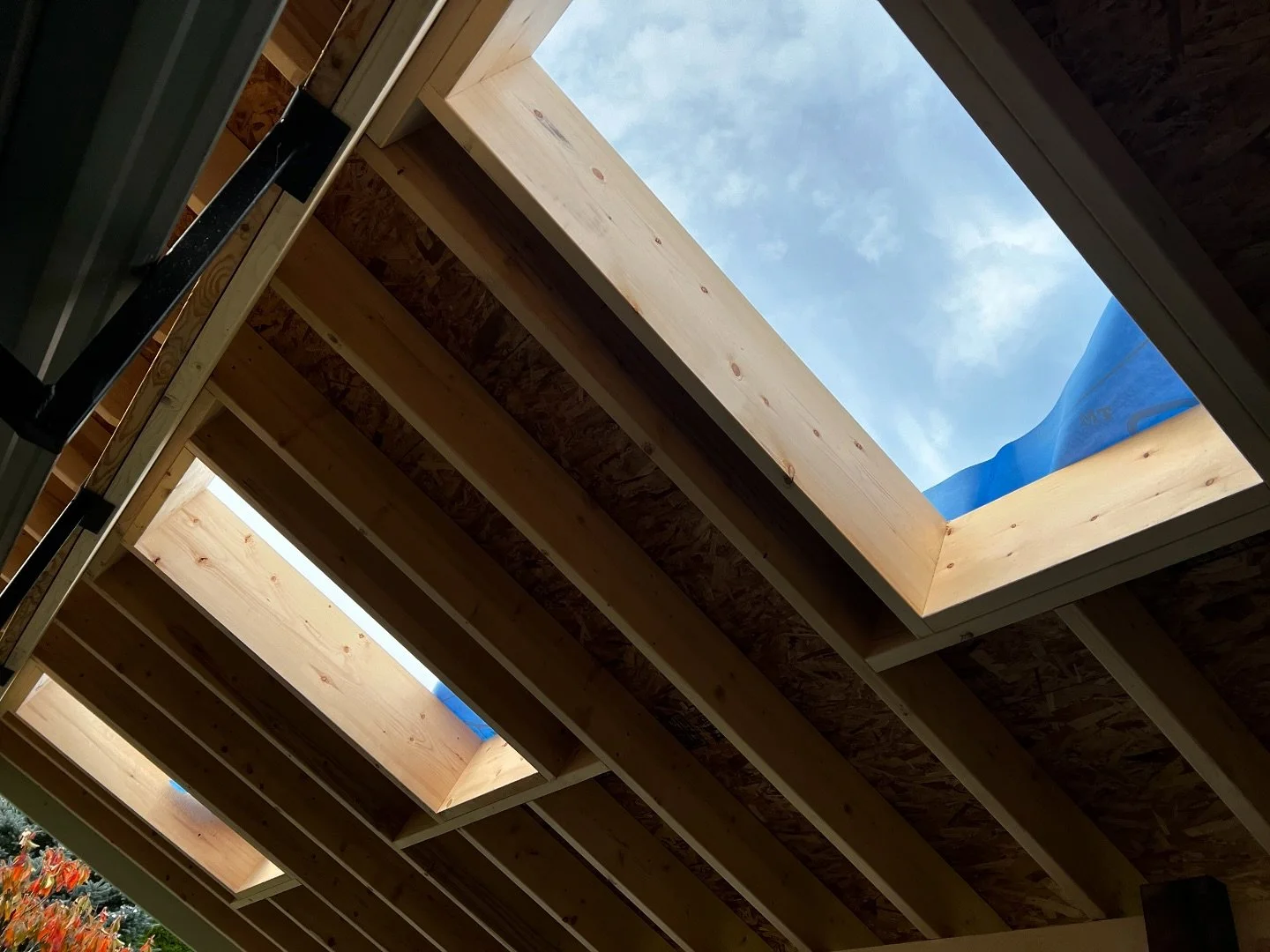Originally this roof was simply decorative rafters open to the elements. However, the new owners saw no sense in having a decorative structure in this wet climate. By building a new roof, this deck area is now useful in any weather. Three skylights w