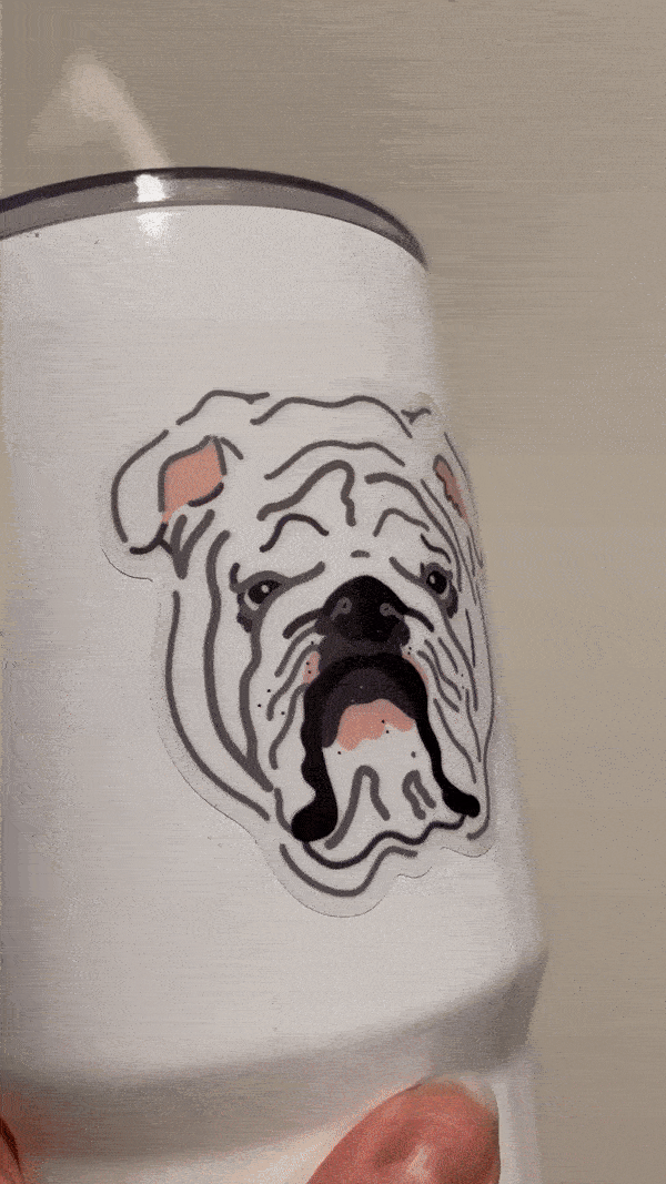 close up video of white bulldog sticker stuck on white metal water bottle