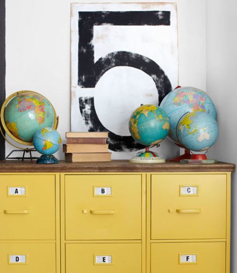How cool is this collection of world globes simply displayed on top of a chest of drawers? Image source: Country Living
