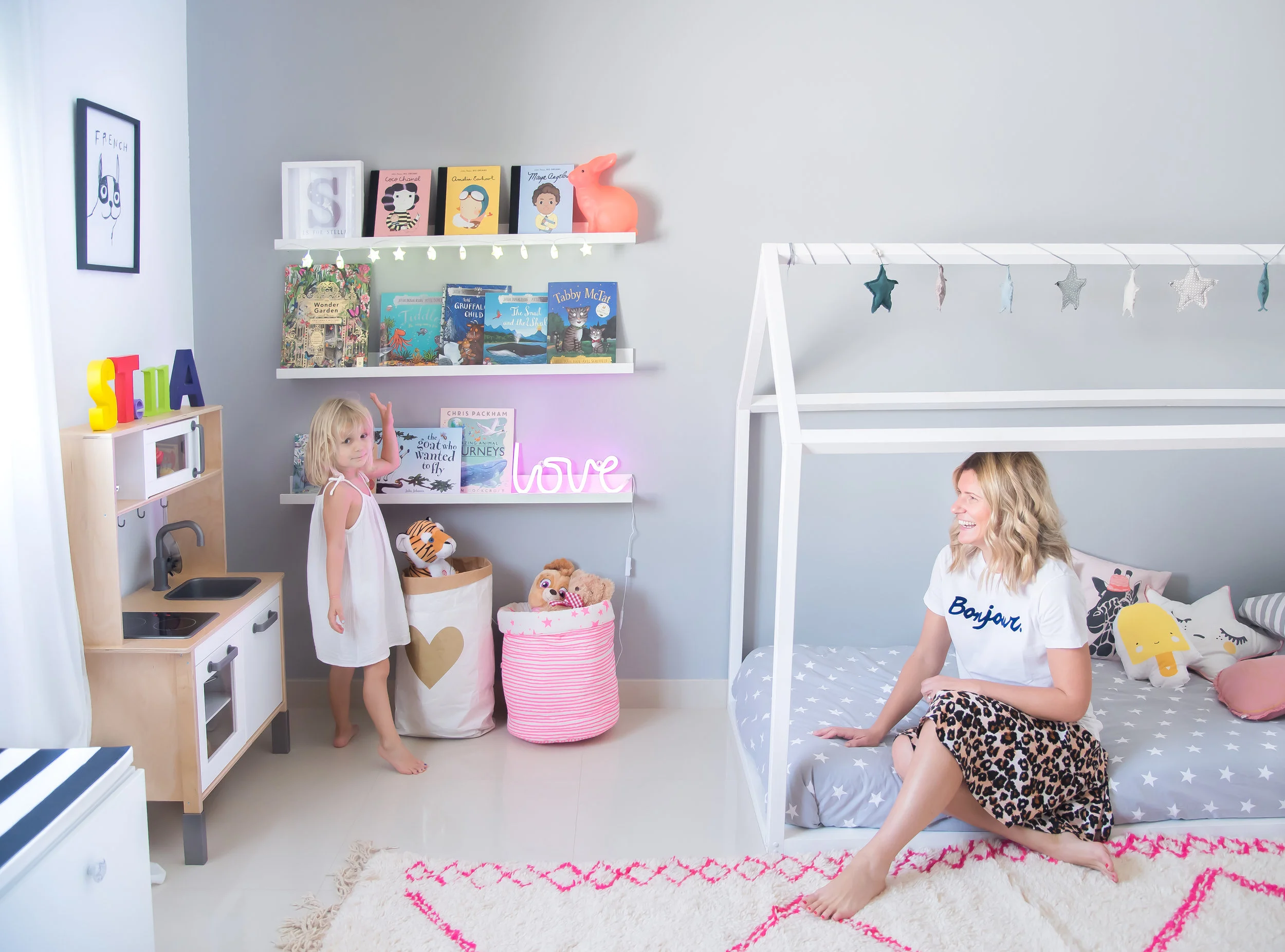 Stella very happy wtih her star string lights and pink love neon light. photo credit: Karen Pissarra @designk