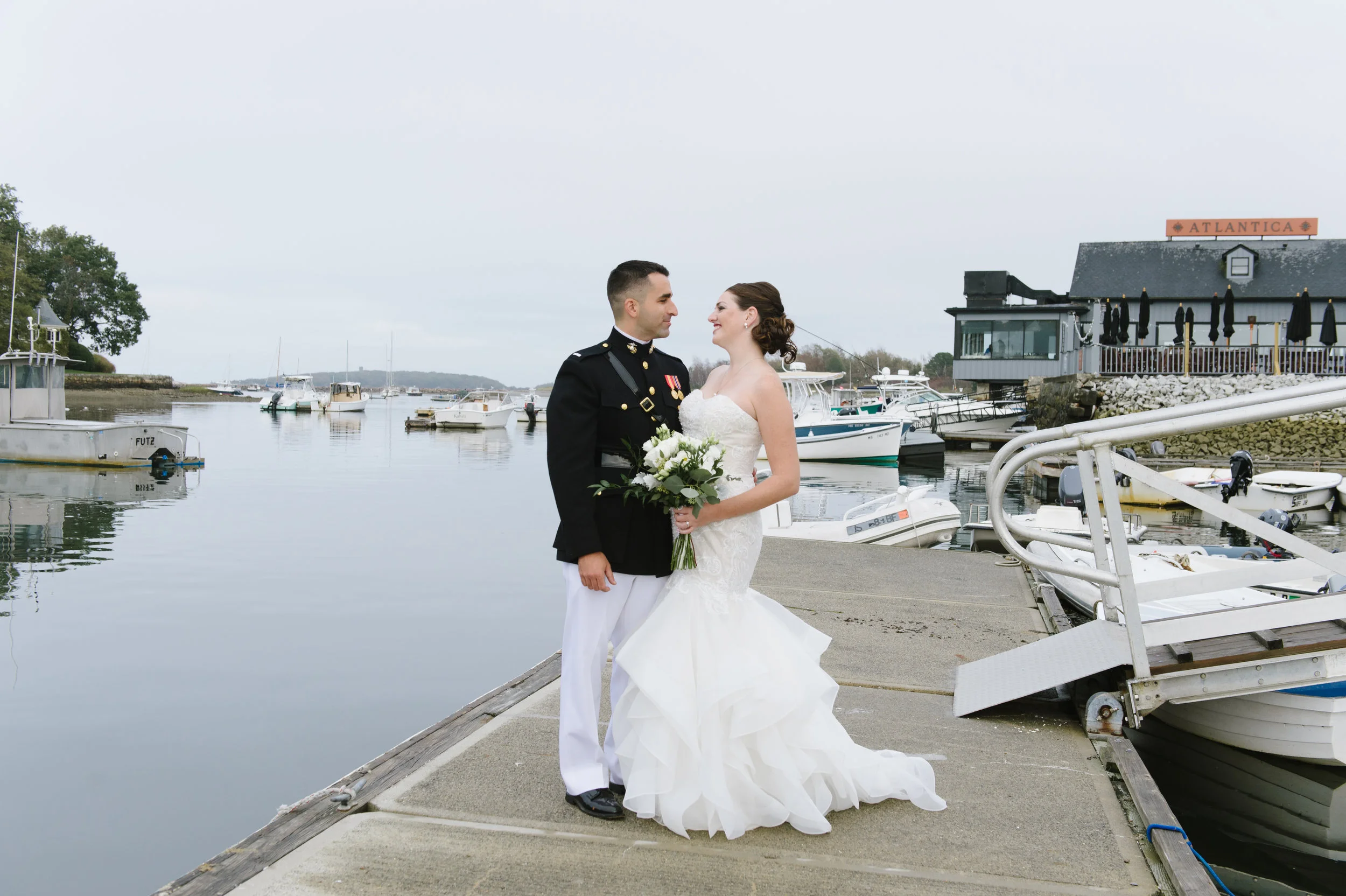 Bride and Groom standing by the dock outside The Atlantica, Cohasset on their wedding day