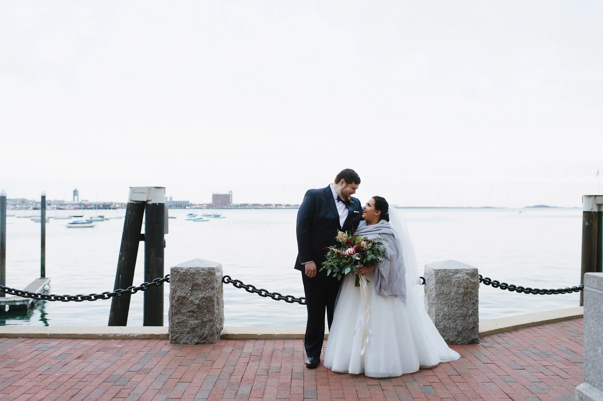 Couple standing at the Boston Waterfront on their wedding day