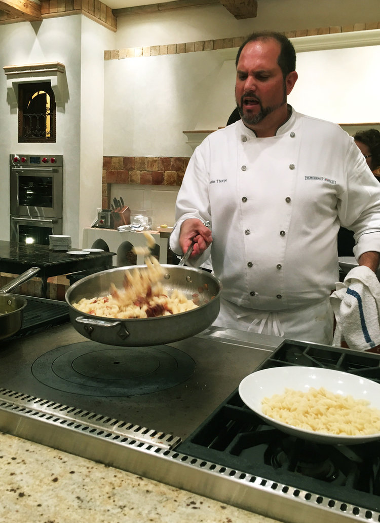 Justin Thorpe, in-house chef, preparing the gluten free carbonara pasta! Cooking lessons using the famous Wolf French Top cooking surface.