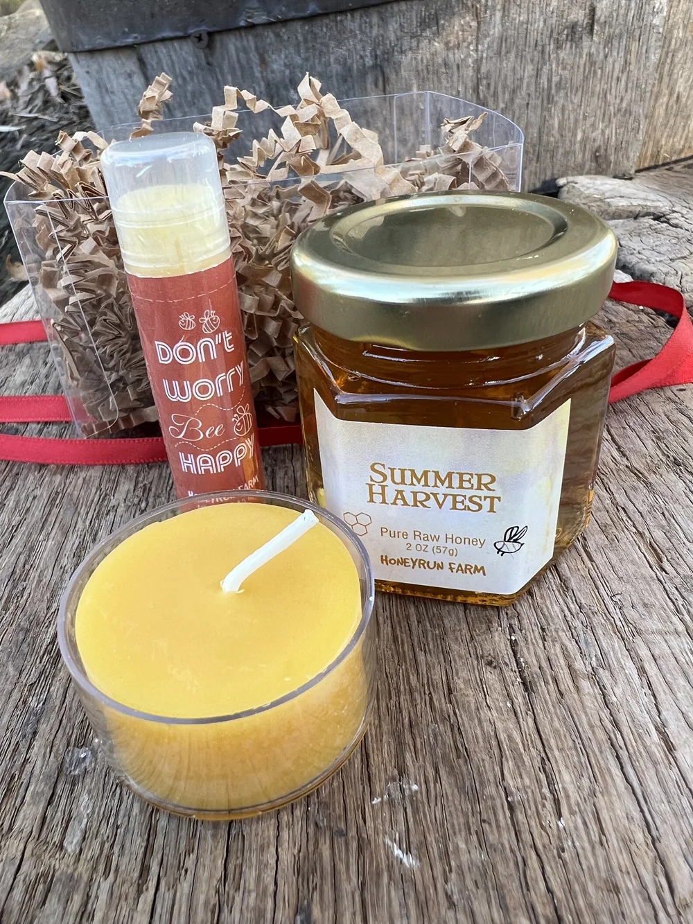 Small gift box with summer honey, tea light beeswax candle, and