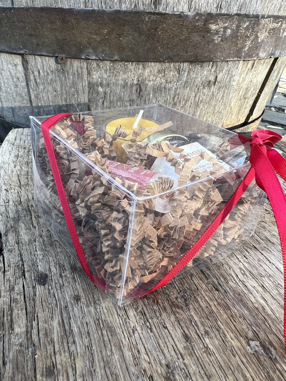 Small gift box with summer honey, tea light beeswax candle, and