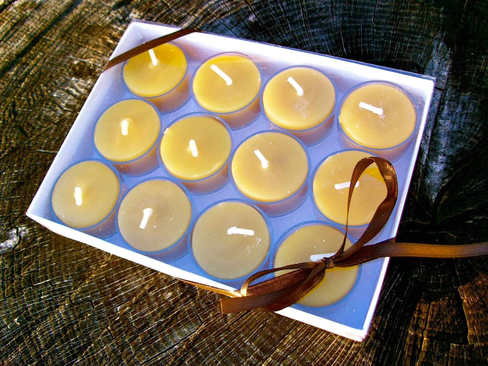 Boxed Tea Light Gift Set -12 Natural Beeswax Tea Lights in clear plastic cups in a gift box with a ribbon