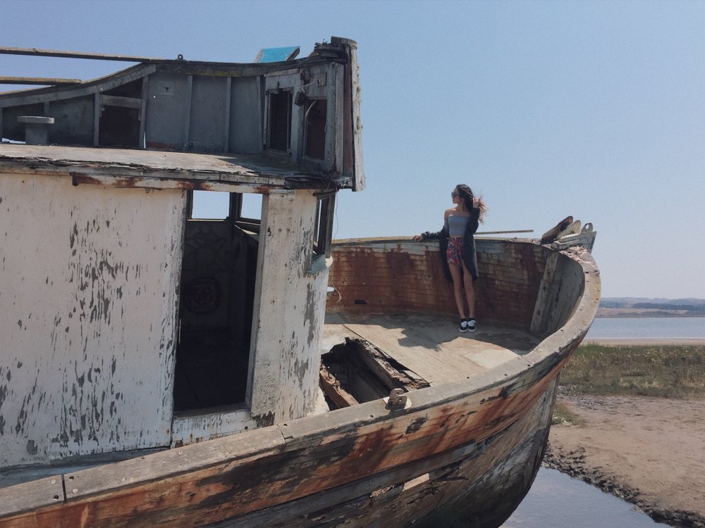 Taking photos with the old rotten ship at bay