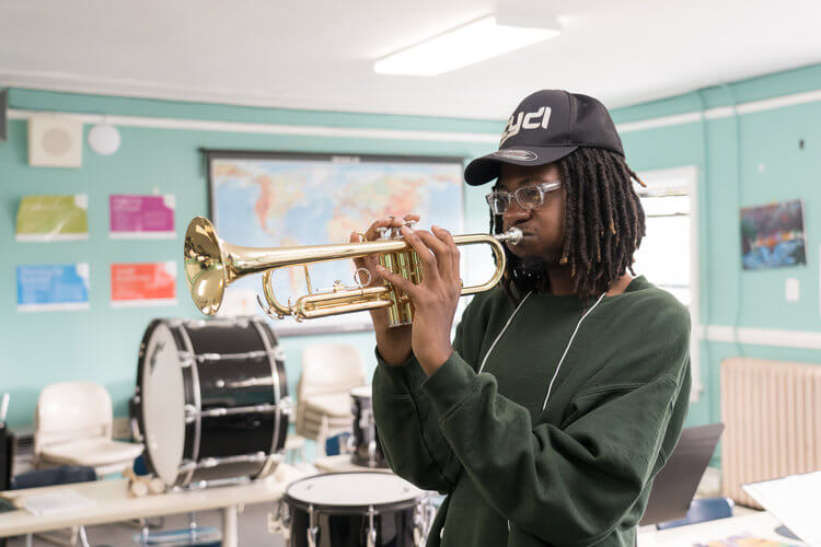  Community Youth Development Institute Student Playing Instrument