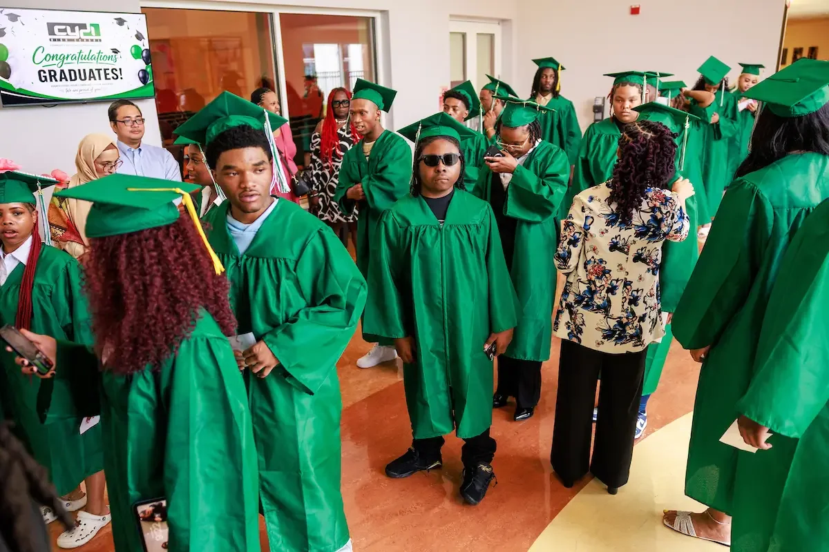 CYDI Student standing in the lobby before graduation