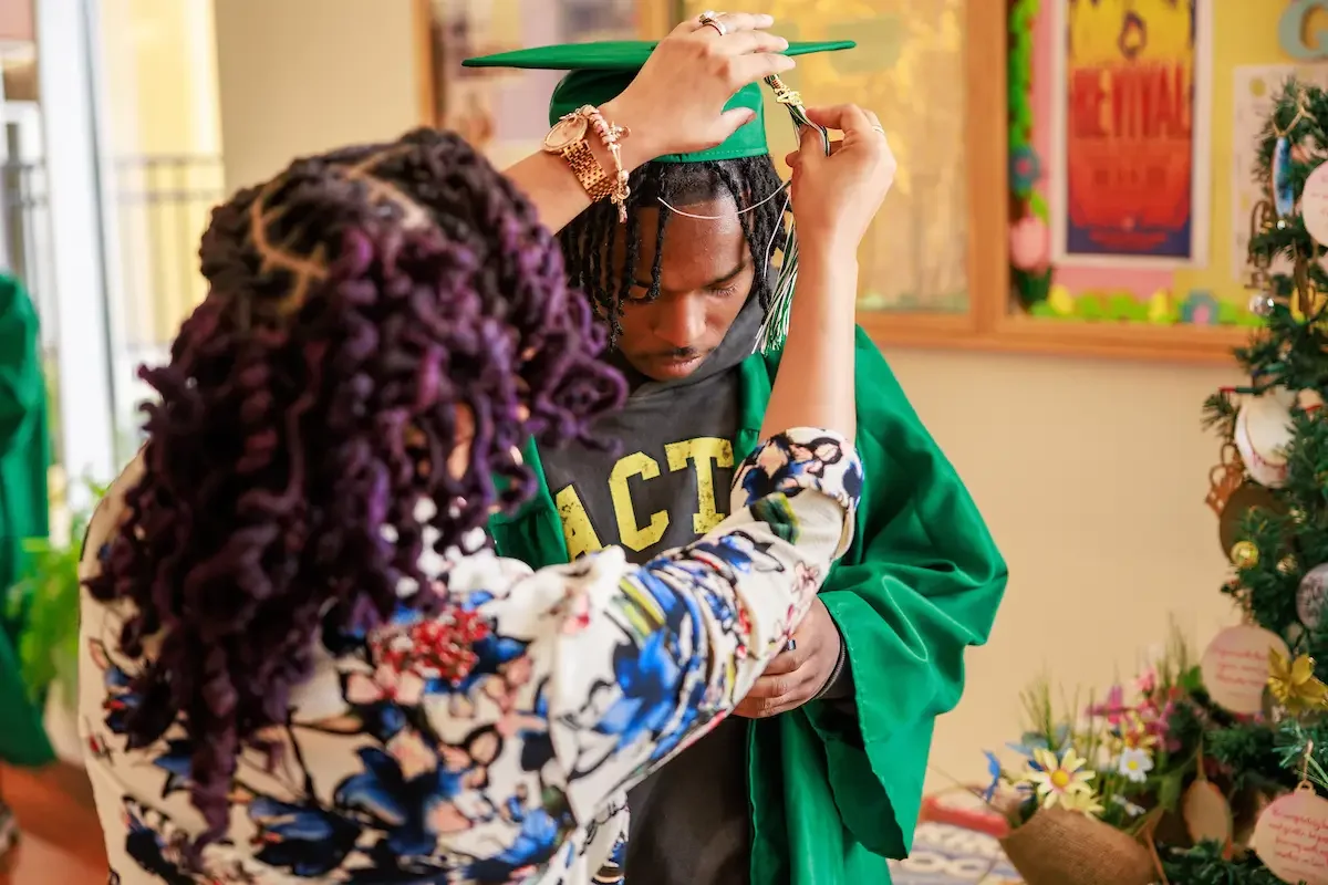 CYDI student getting cap adjusted