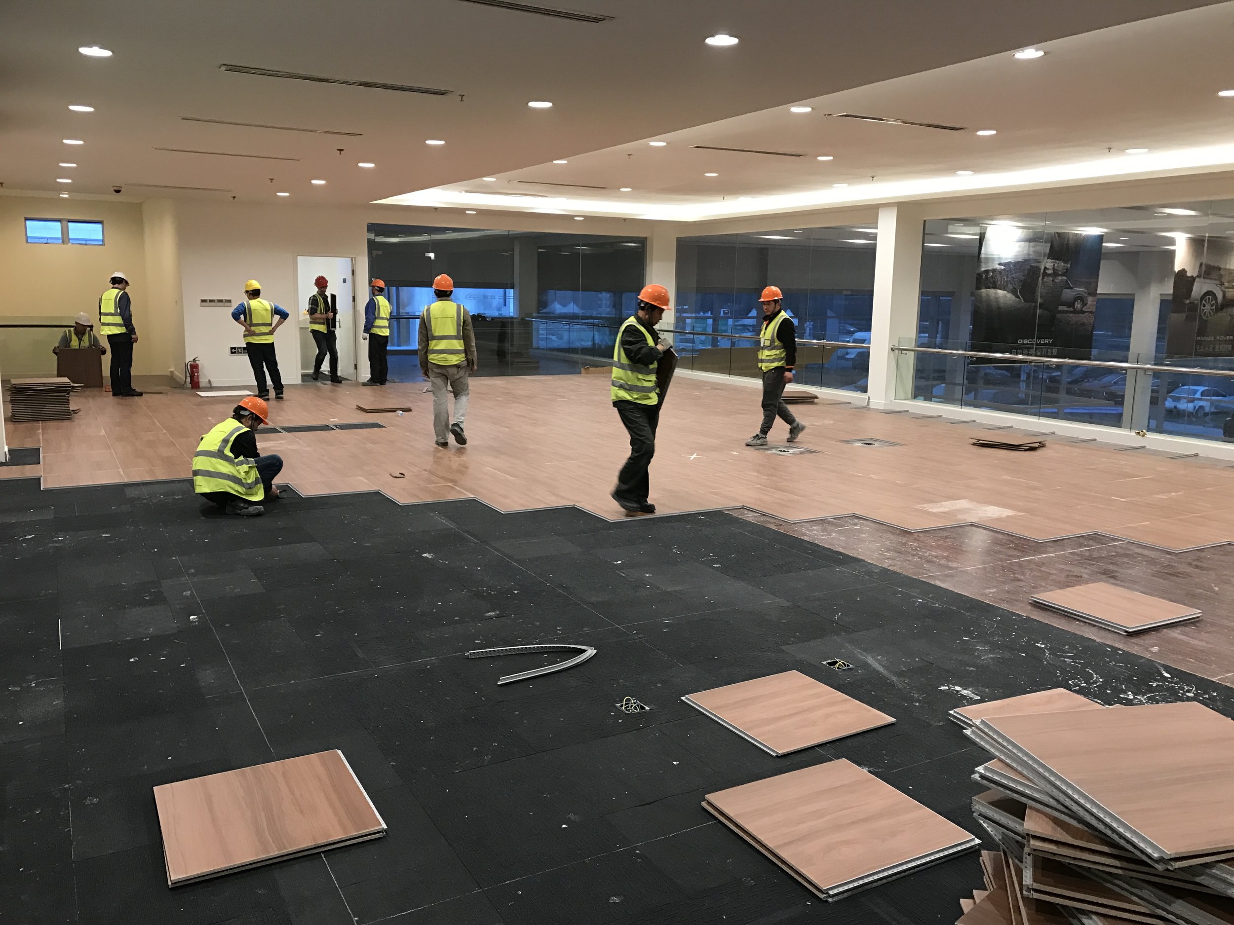 Installation day 1: Versaflex® cross installed in lounge area (adjacent to main showroom) directly on multiple substrates of LVT and carpet tiles