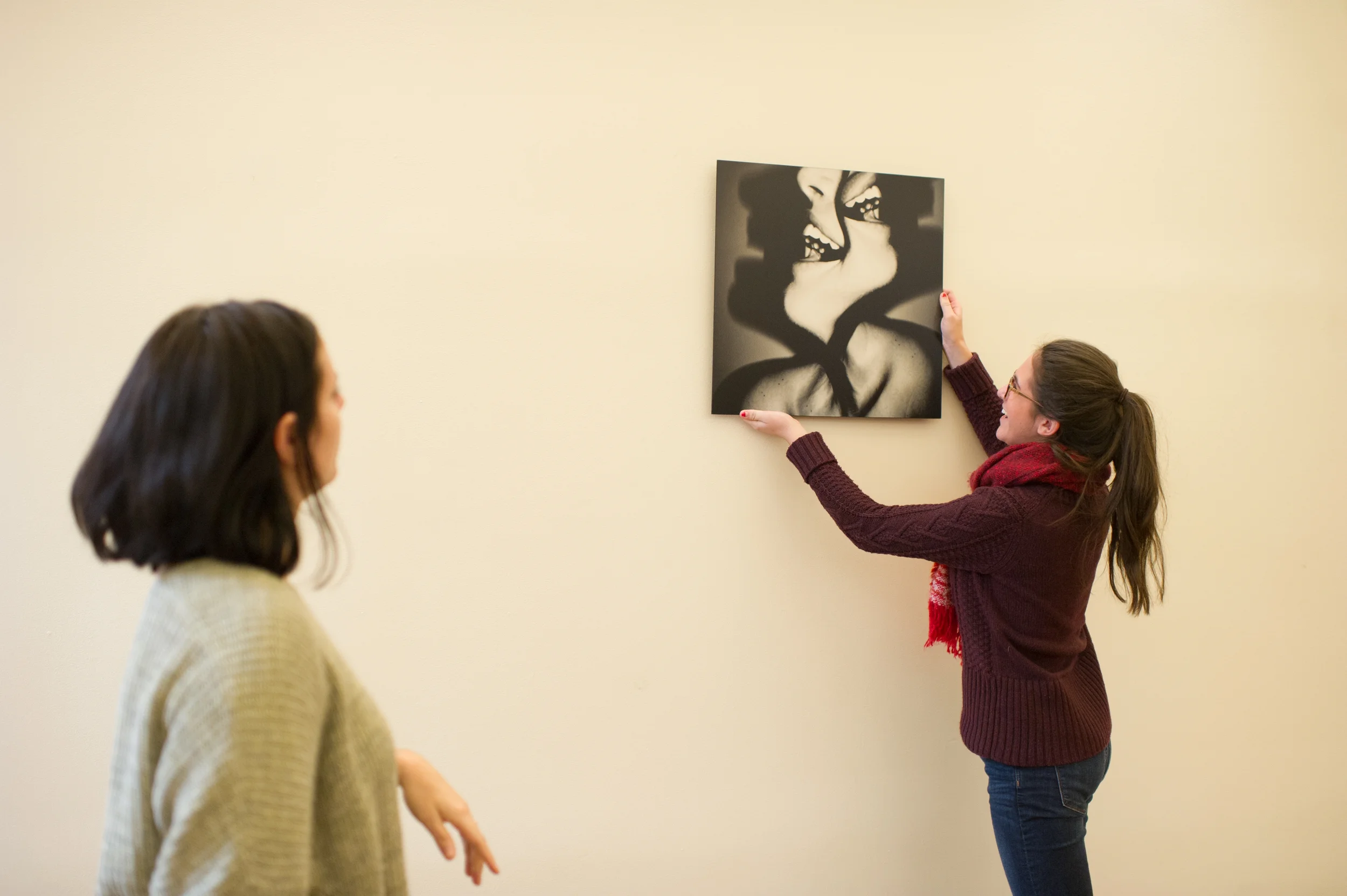 Future Is Now participants work to install their exhibition at the Green Building Gallery