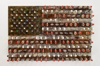 "Consume" by Bryan K. Holden, 48x72x9in, Plastic Liquor Bottles, Cardboard Homeless Signs, Wood, Resin, Ink, Paint, Liquor, Cigarette Butts, Pills, Syringes, Keys and Wedding Ring