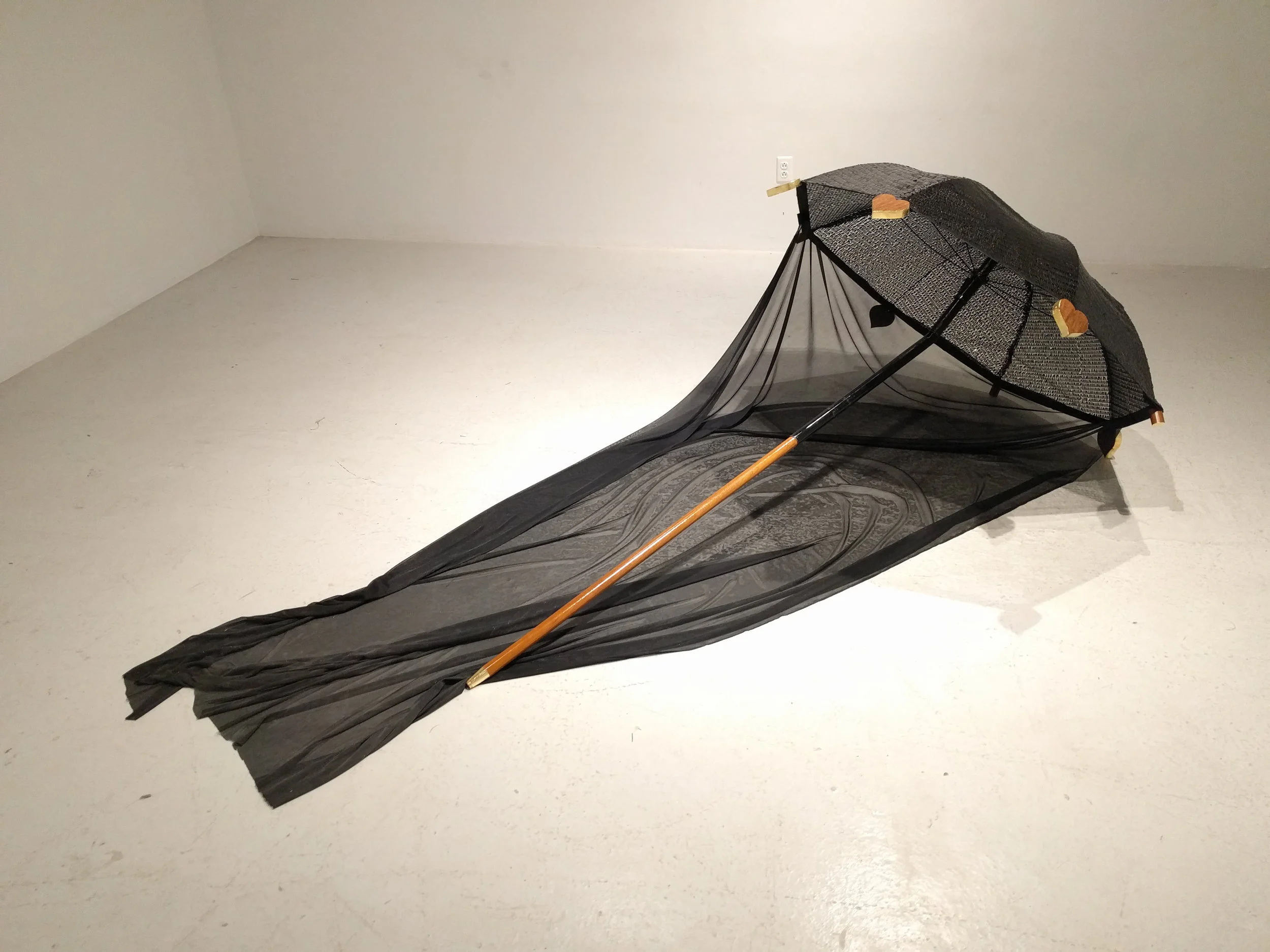 "Tall black personal enclosure" by Tammy Burke, umbrella frame, wood, gold leaf, sequined fabric, 48x82in, 2018