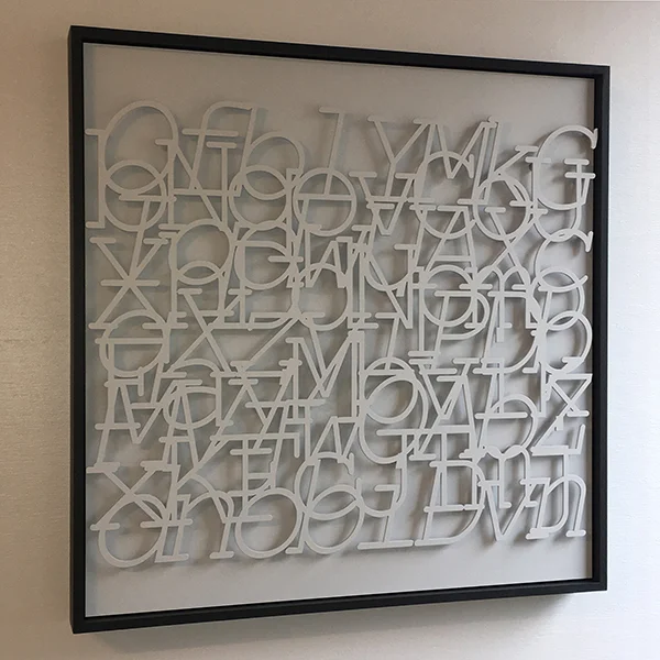 “Sonnet” by Steve Heine, random text, laser-cut steel, small-diameter magnets, primer, poplar, 30x30x2in, 2019, $3900