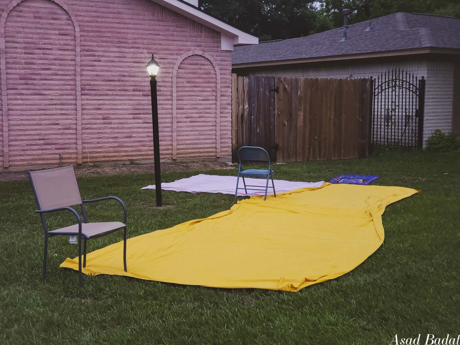 The chairs were used to pin the sheets to the ground. Also, the yellow sheet looks like American cheese.