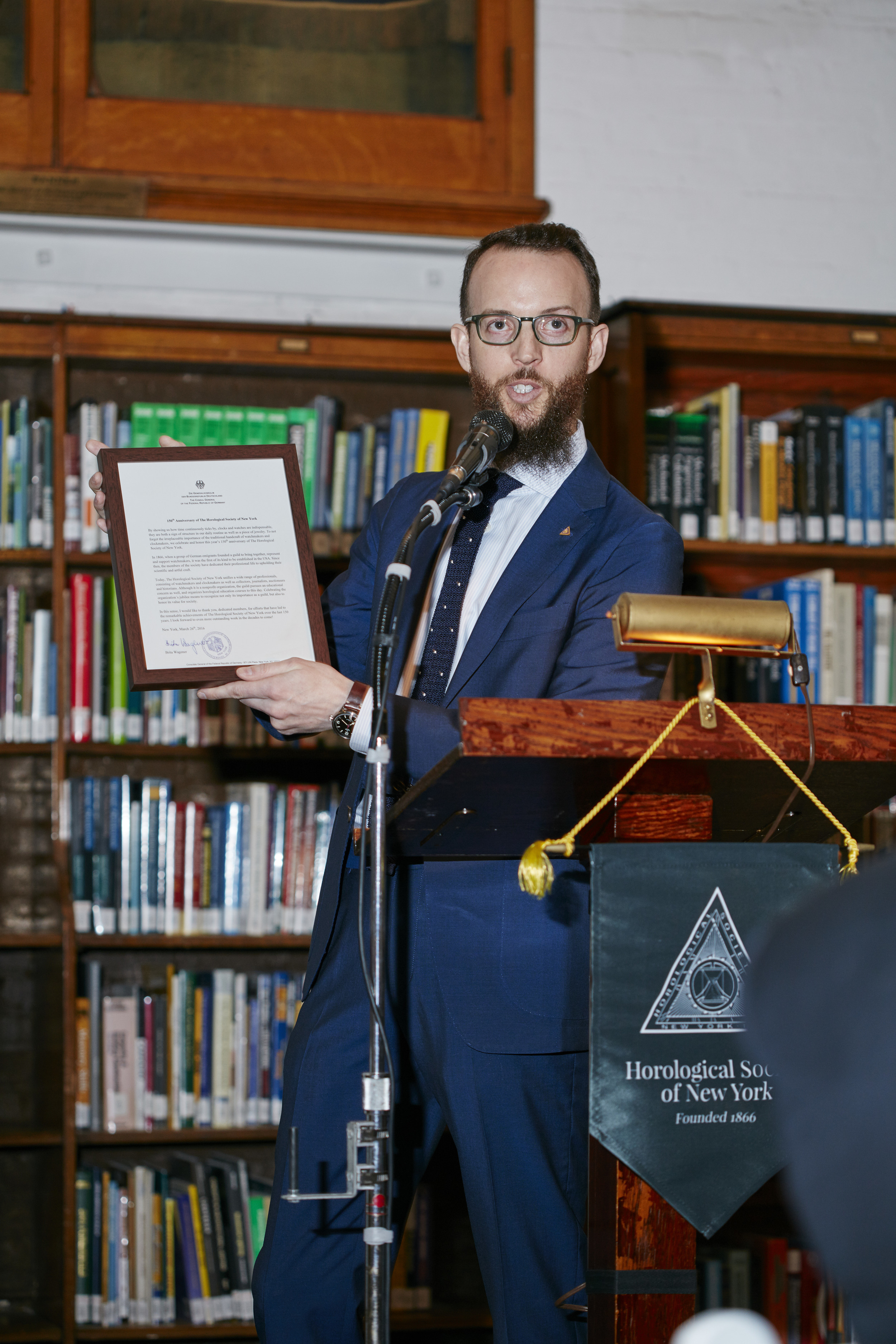   Nicholas Manousos, Vice President of HSNY,&nbsp;presenting a proclamation from the German government  