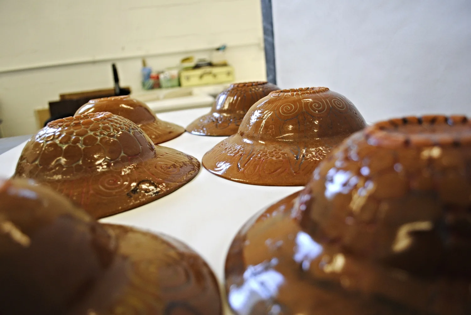 Hand-built ceramic bowls upside down showing textured decorative surfaces from a pottery class in West Hampstead