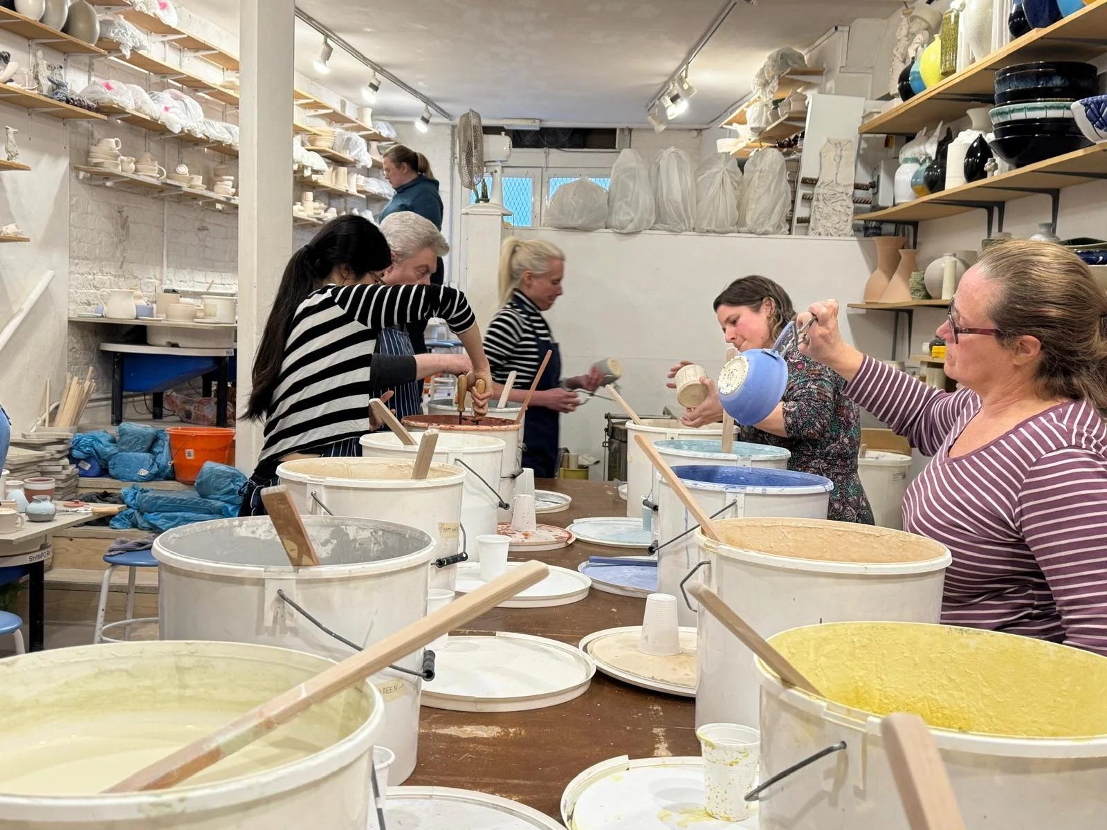 students glazing their ceramic work at Ceramics Sculpture Studio