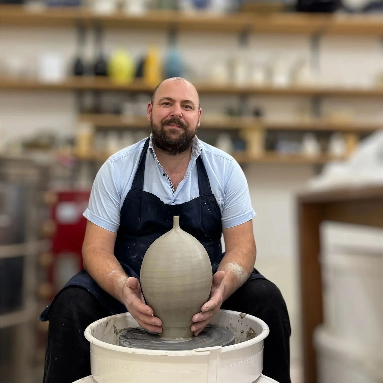 Ceramic artist Cosmin Ciofirdel shaping a vessel on the pottery wheel in West Hampstead