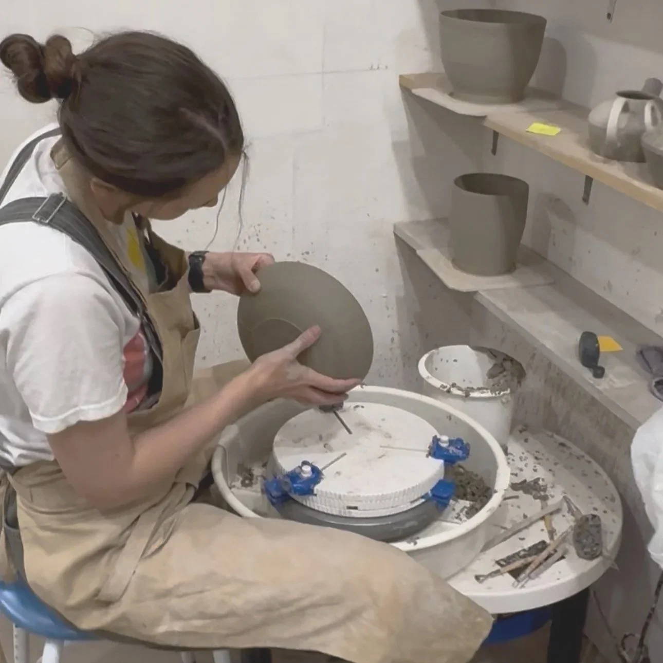 student trimming a plate at Ceramics Sculpture Studio in West Hampstead