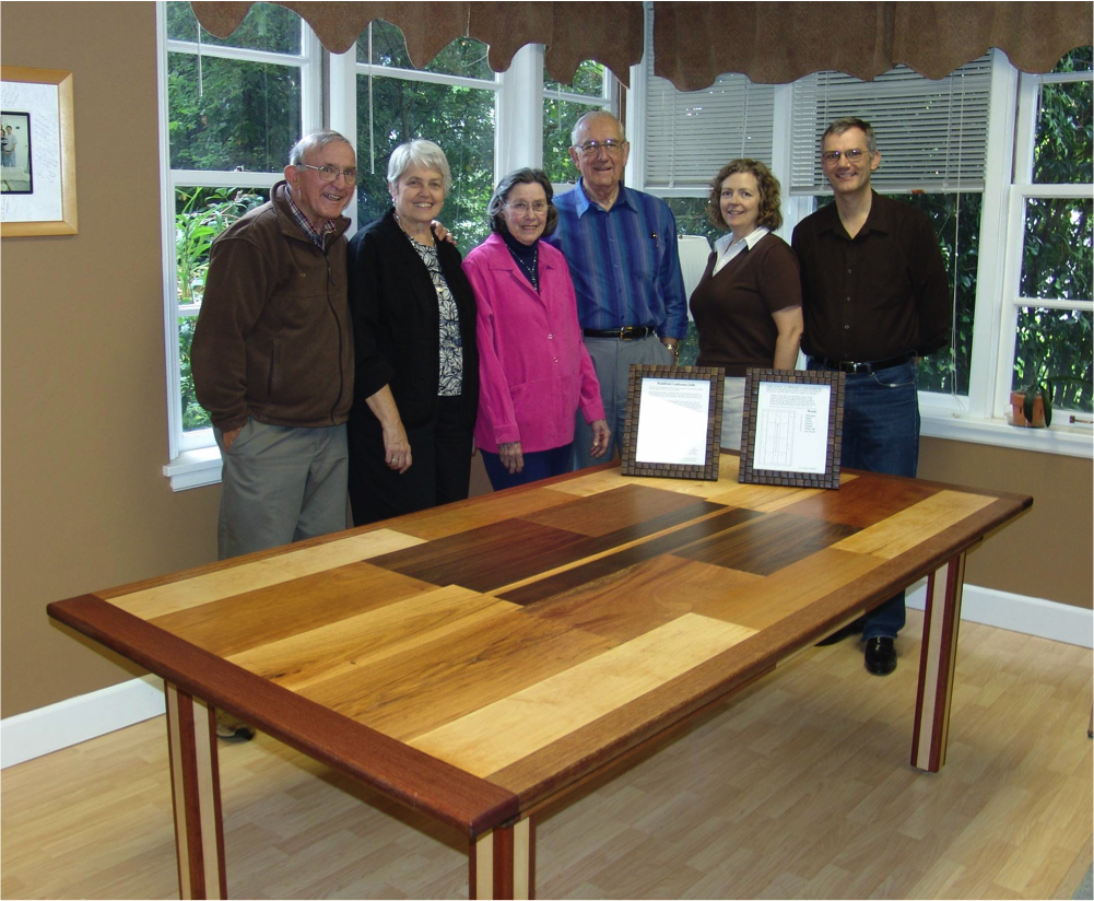 From Left to Right: Table maker E. R. Krueger, his wife, Mrs. & Dr. Smith, and staff at WorldView