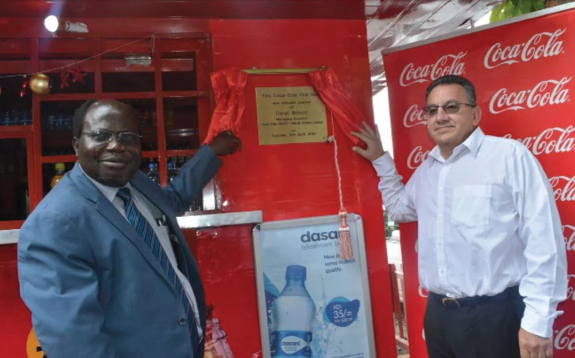 DVC Academic Affairs Professor James Kombo (right) and Managing Director of Coca Cola SABCO Nairobi Bottler’s Limited, Mr. Daryl Wilson officially unveil the Yes! Hub Kiosk