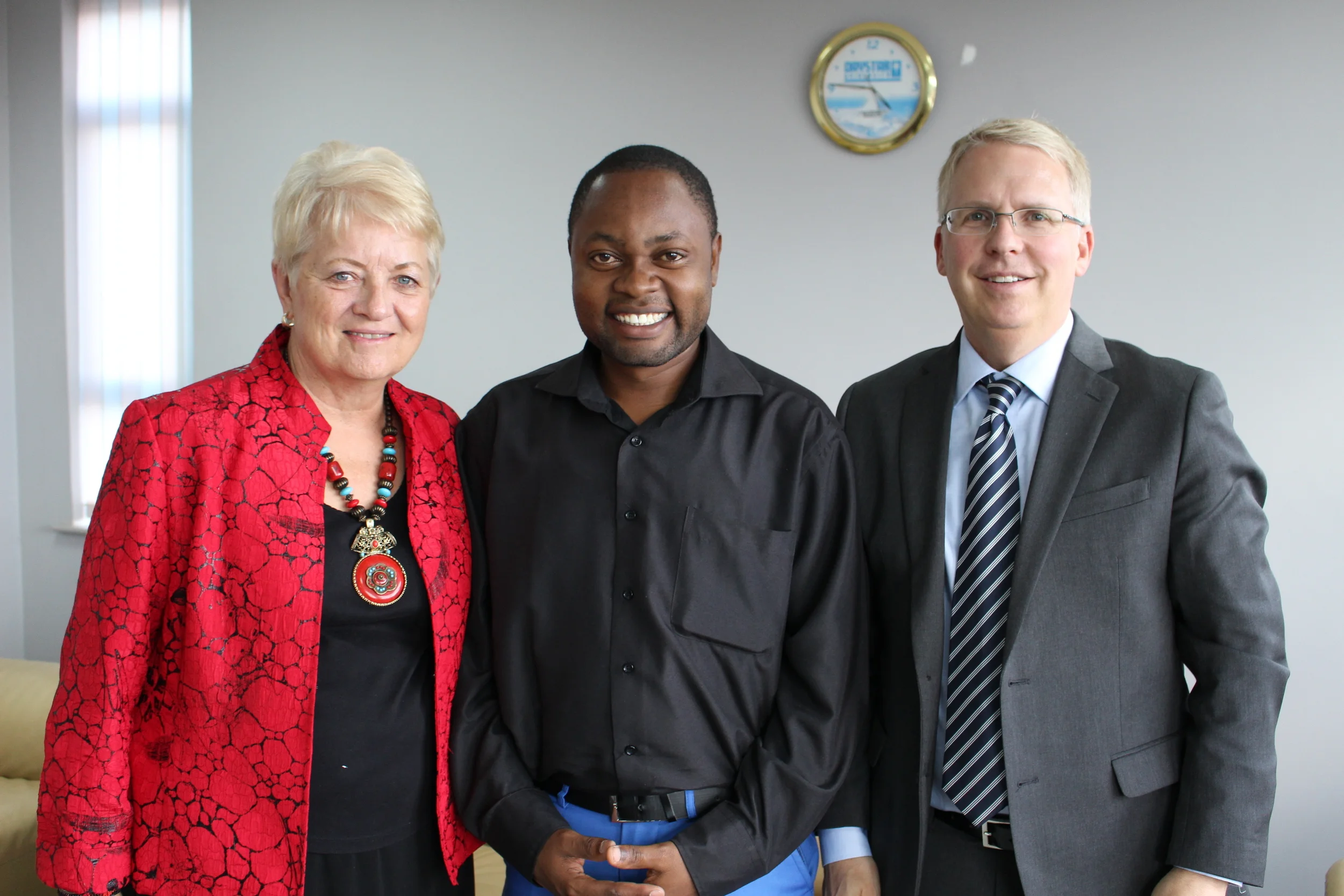 Daystar U.S. Executive Director, Kathleen Johnson, and Jon Halverson, Daystar U.S. Vice Board Chair, with Victor, a student supported by Daystar U.S.