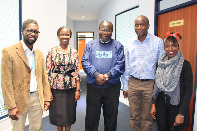 The Deputy Vice Chancellor of Academic Affairs, Dr. James Kombo, stands with the two beneficiary students, together with their sponsors, the Class of 1996, represented by Ms. Catherine Butaki (second left) and Mr. George Menge (second right).
