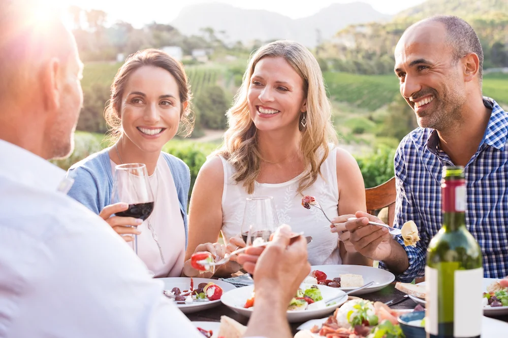 Mature friends enjoying eating