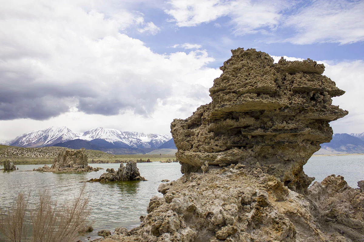 Tufa on the lake with the Sierra’s in the background along with rain.