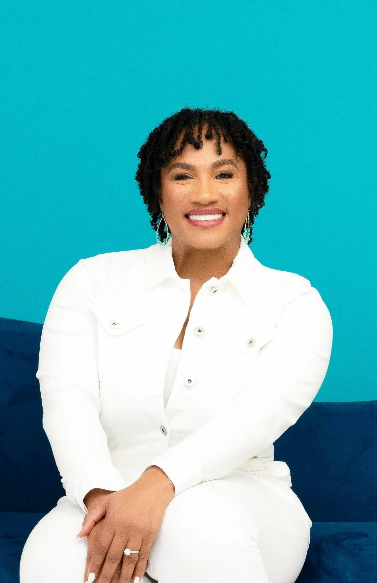 Candace Reese, Founder of Are You Ready for College is pictured sitting on a couch.