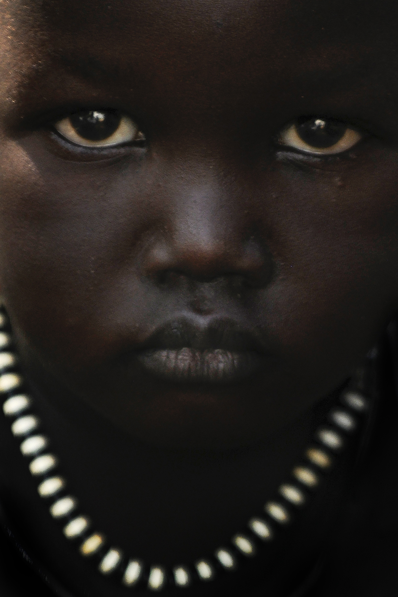 A young girl attends a health education event outside John Dau’s Lost Boys Clinic in Duk Payuel. Dau’s decision to build a clinic is personal: Three of his siblings died when they were infants because of the lack of health care. He saw many childhood friends die from cholera, typhoid, measles and whooping cough as they journeyed to Ethiopia to escape the civil war. With the renewed violence in South Sudan, a new generation of children are at risk today.
